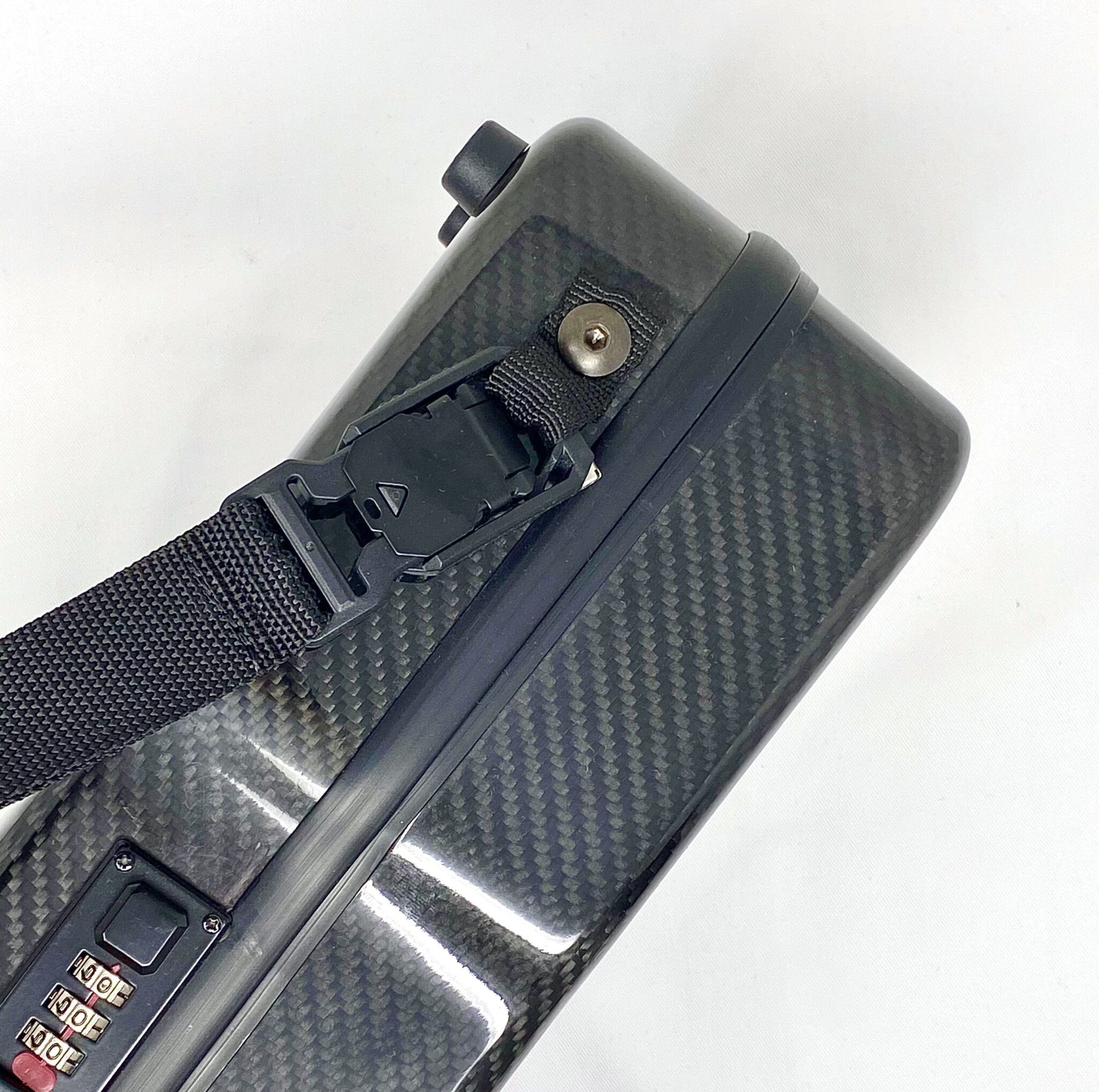 Castellani carbon fiber shotgun case with shoulder strap in magnetic hooks.